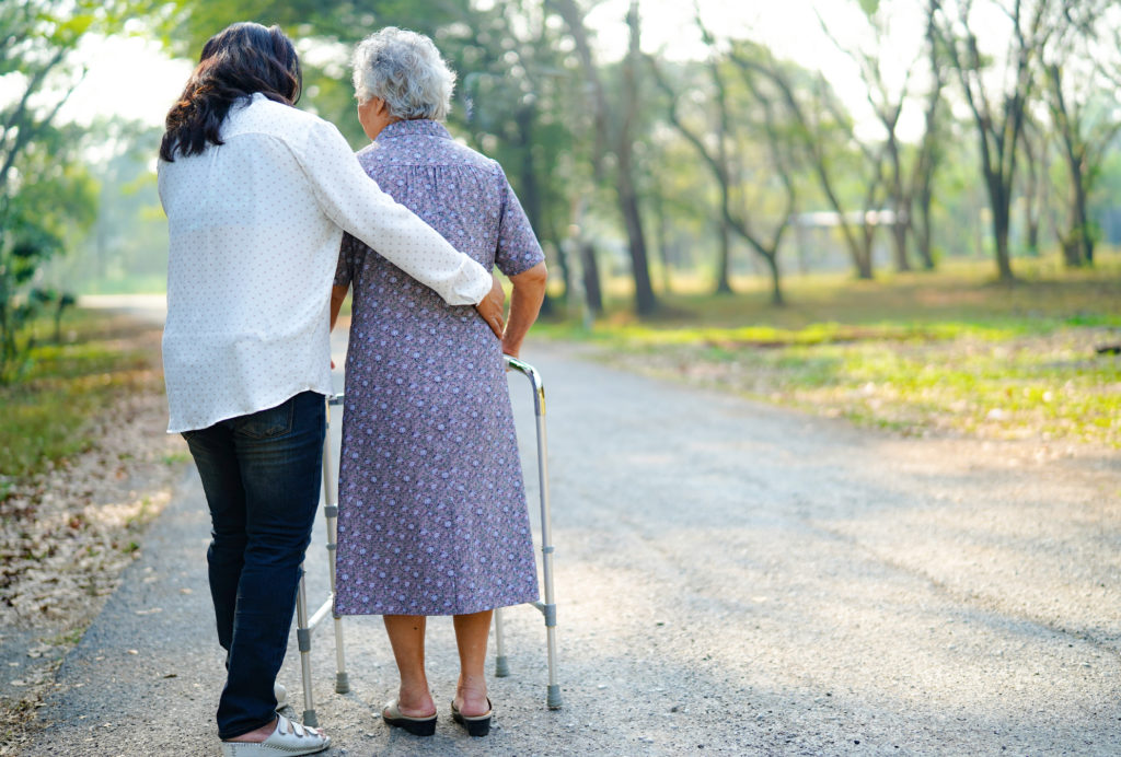 Woman walking with elderly person
