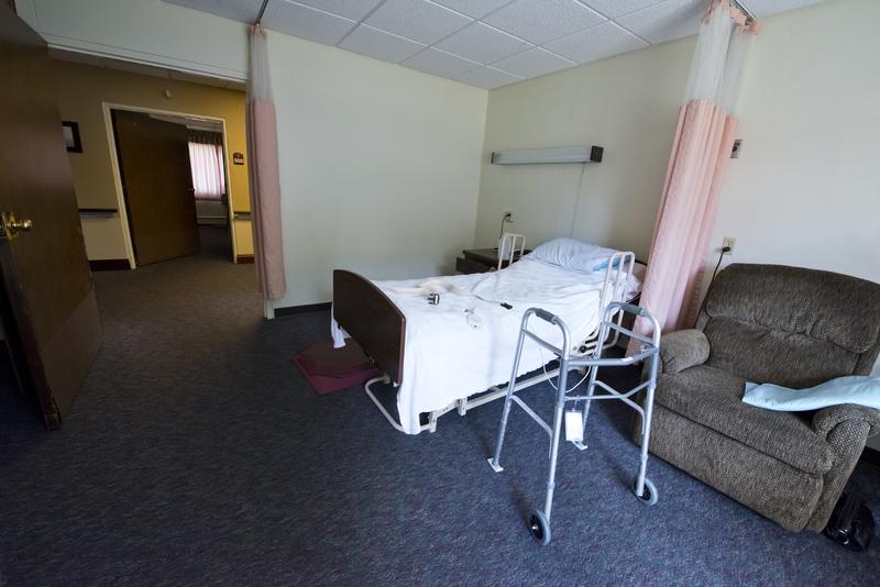 Hospital bed and walker in an assisted living facility