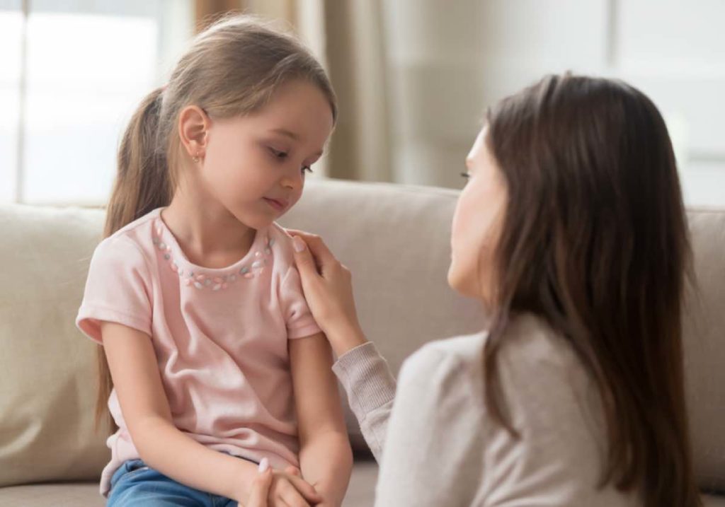 Woman helping young child understand loss and grief